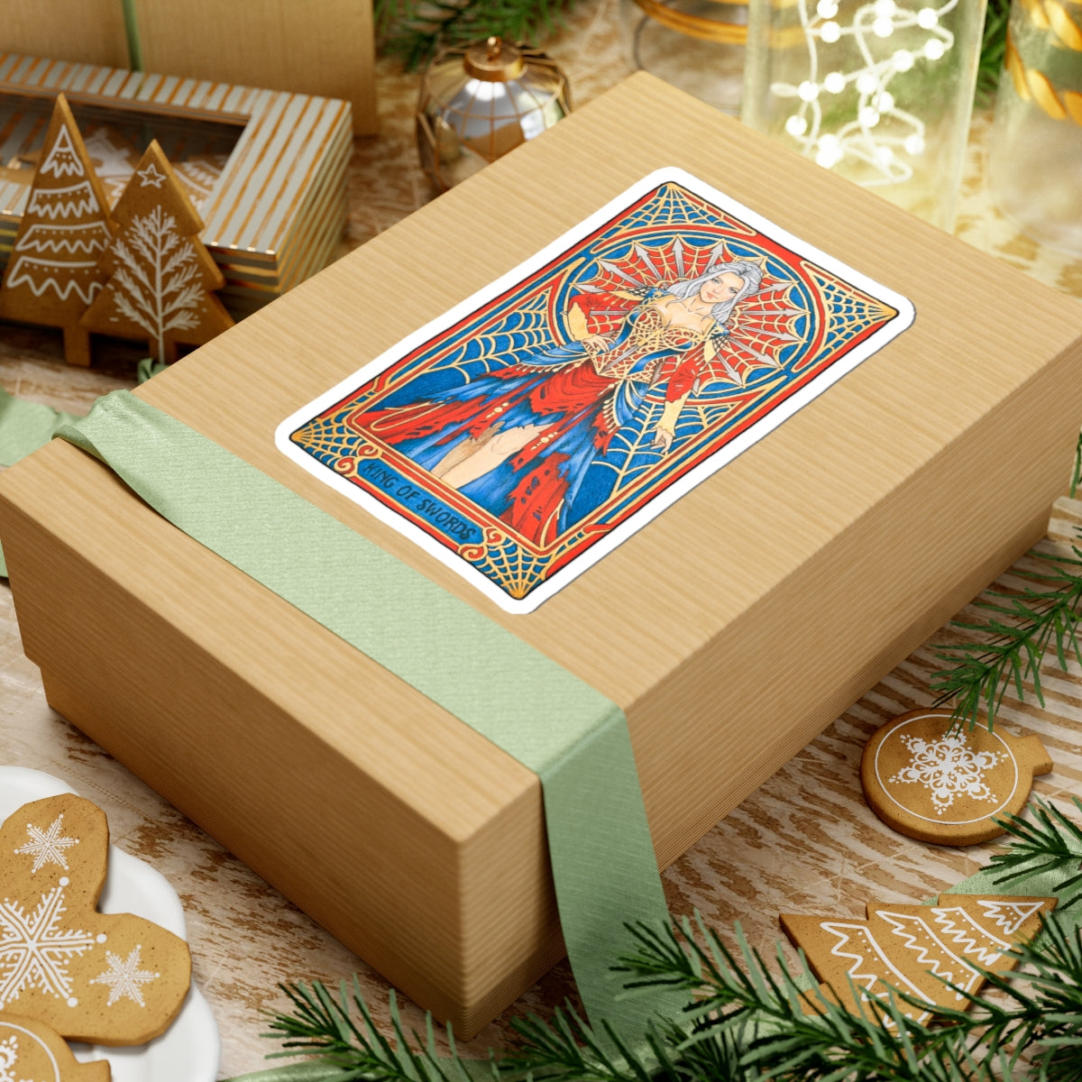 King of Swords tarot kiss-cut sticker: silver-haired figure in a red and blue gown with a spiderweb halo